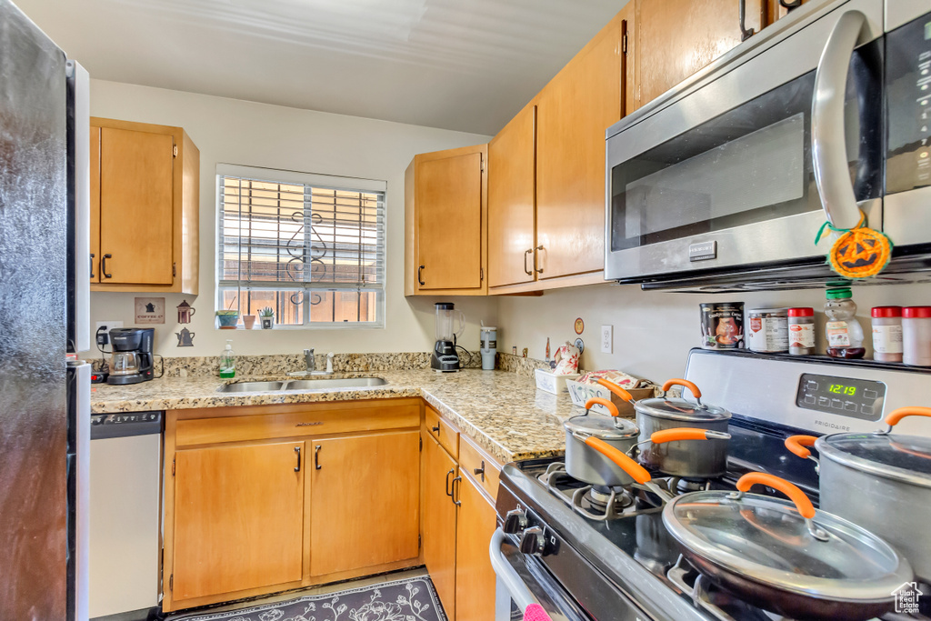 Kitchen featuring appliances with stainless steel finishes and sink