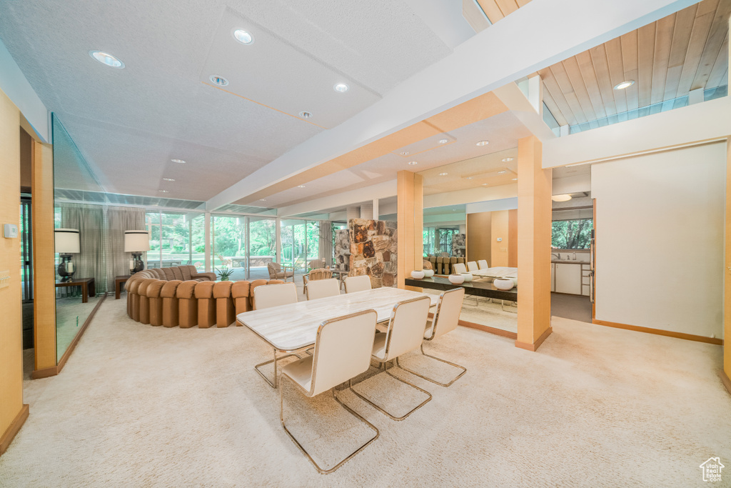 Dining area featuring light colored carpet
