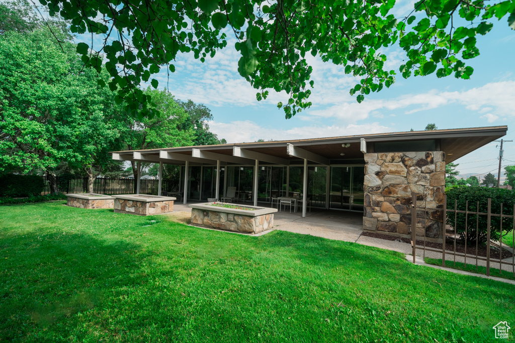 Rear view of house featuring a yard and a patio area