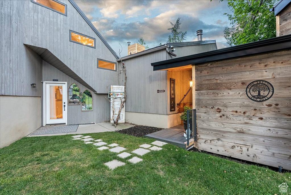 Doorway to property with a yard