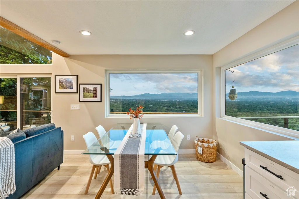 Dining area with a mountain view and light wood-type flooring