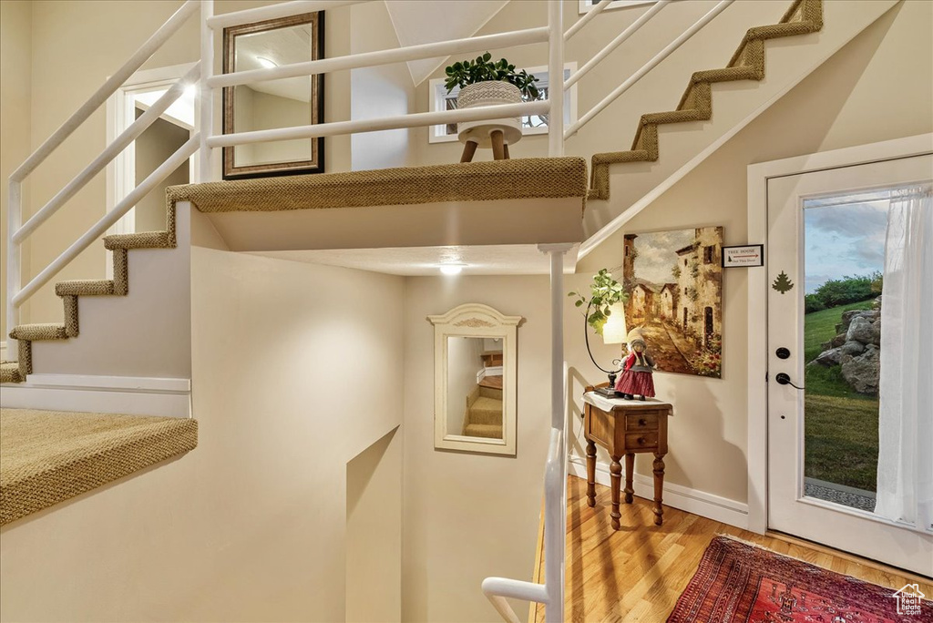 Stairs featuring hardwood / wood-style floors