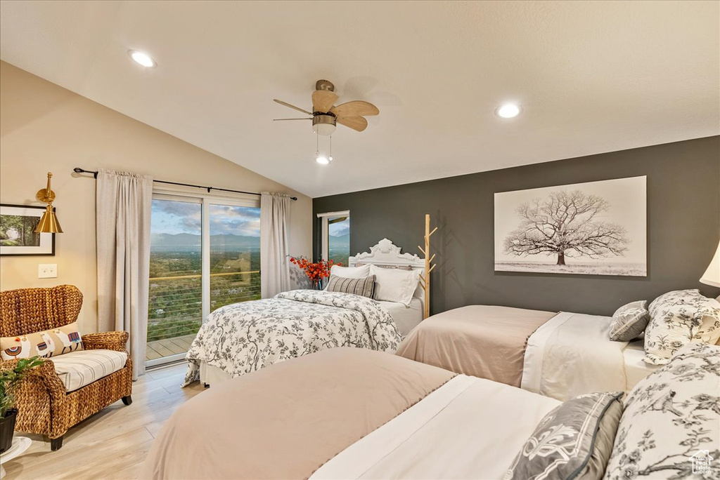 Bedroom featuring access to exterior, light hardwood / wood-style flooring, ceiling fan, and lofted ceiling