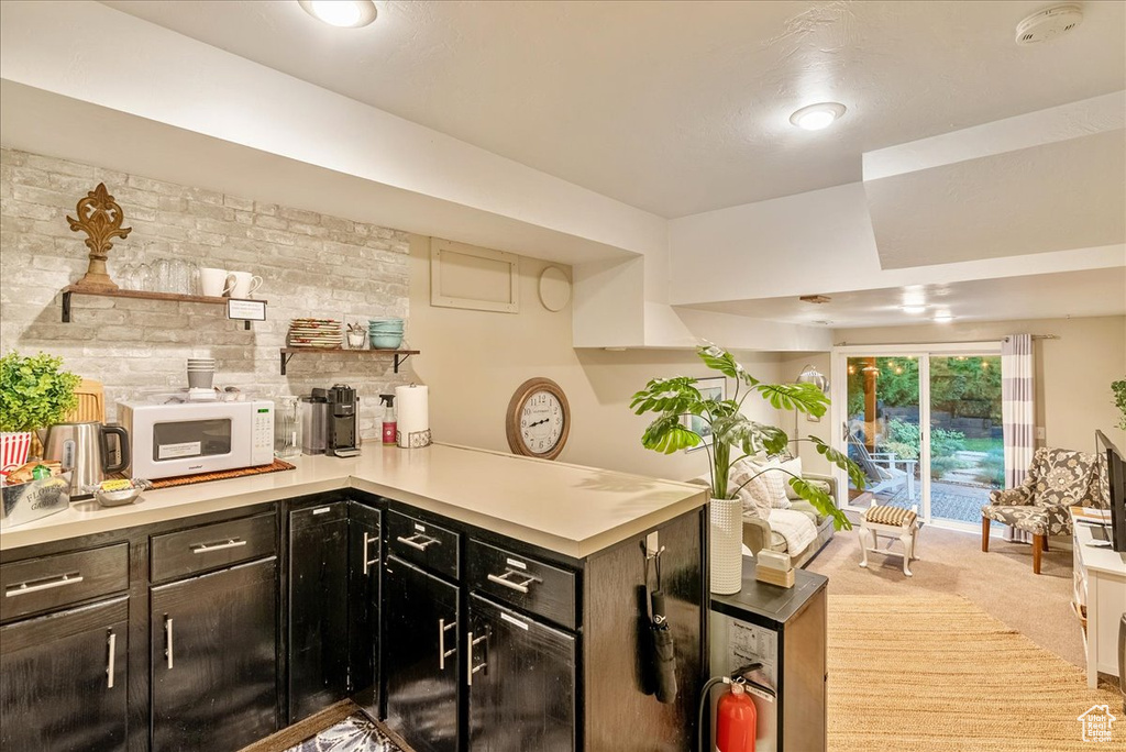 Kitchen featuring light carpet and kitchen peninsula