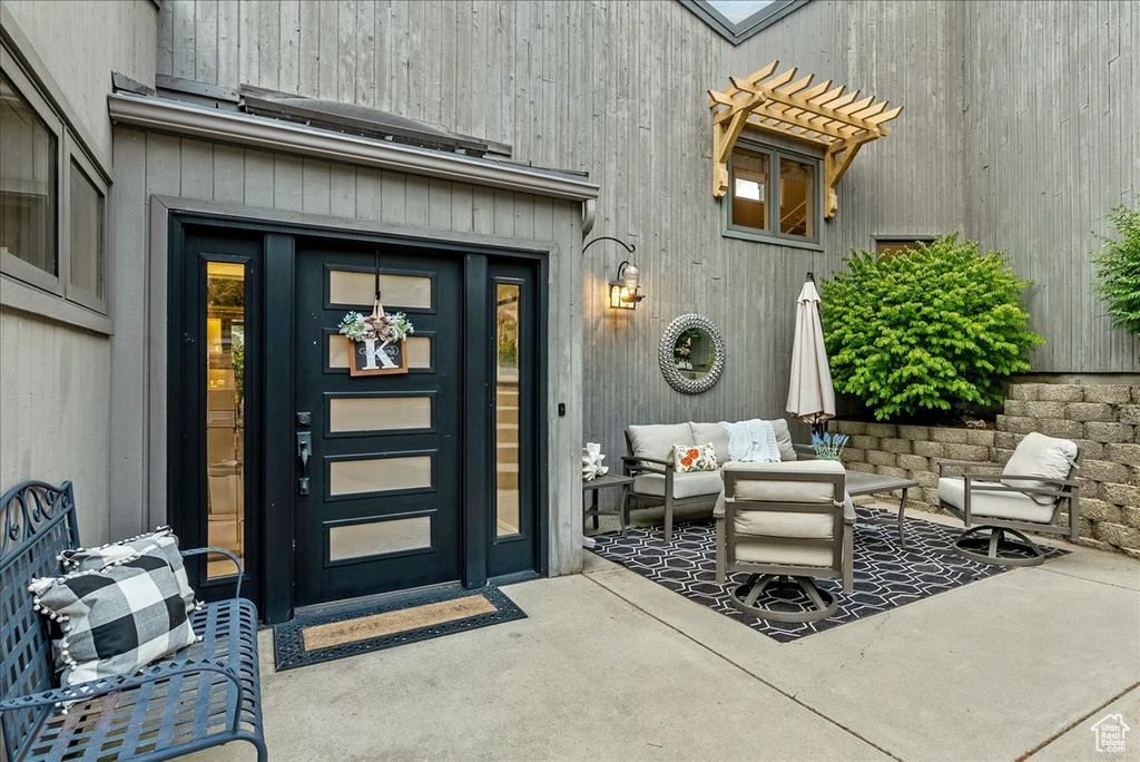 Entrance to property featuring a patio area and outdoor lounge area