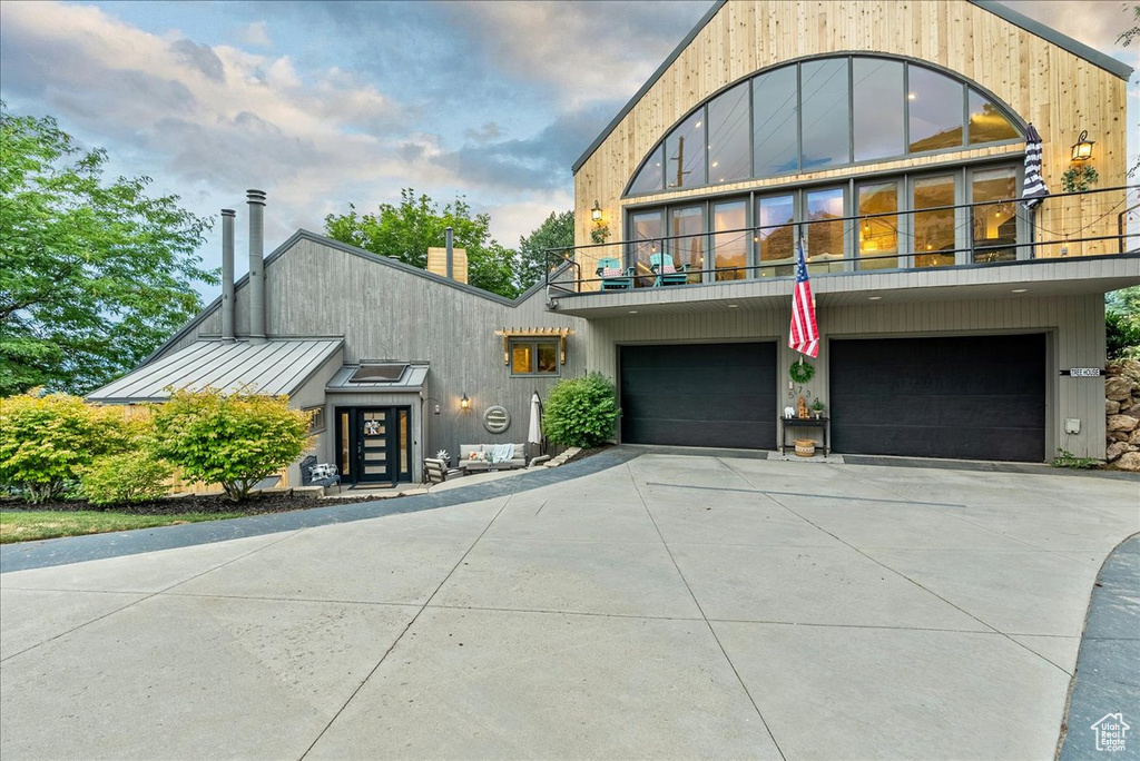 Modern home featuring a garage and a balcony