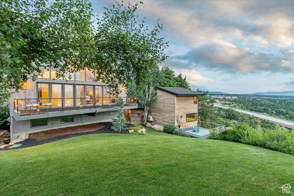 Yard at dusk featuring a wooden deck