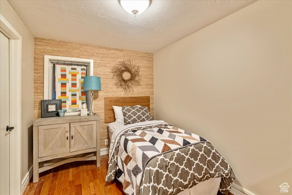 Bedroom with hardwood / wood-style floors