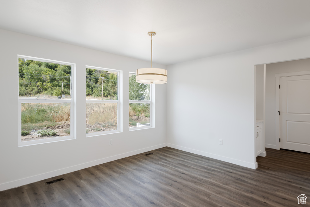 Unfurnished room featuring dark hardwood / wood-style flooring