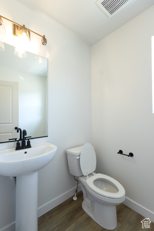 Bathroom featuring toilet and hardwood / wood-style floors