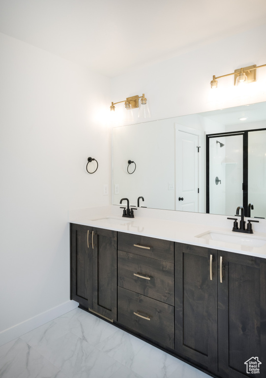 Bathroom featuring tile patterned flooring and double vanity