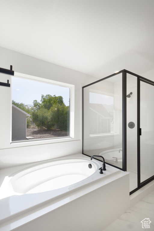 Bathroom featuring tile patterned flooring and independent shower and bath