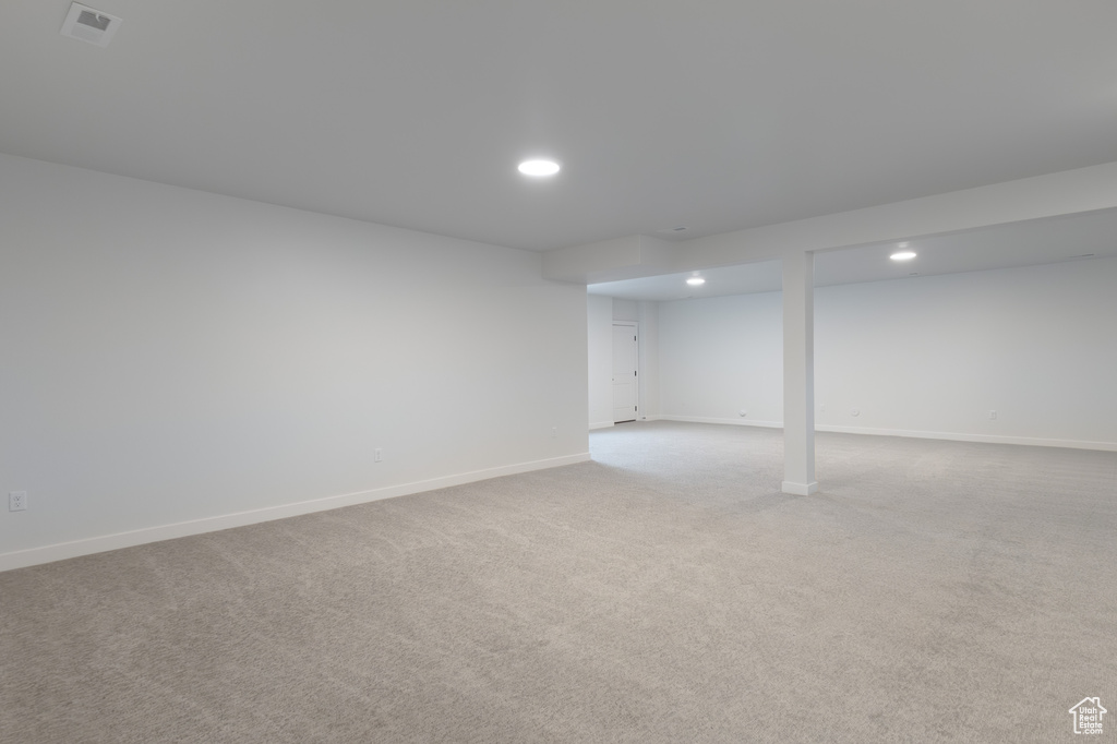 Basement featuring light colored carpet