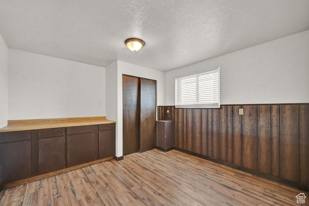 Unfurnished room featuring a textured ceiling and light wood-type flooring