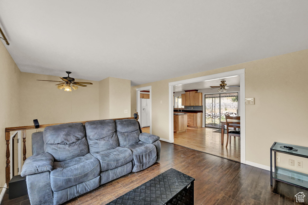 Living room featuring ceiling fan and hardwood / wood-style flooring