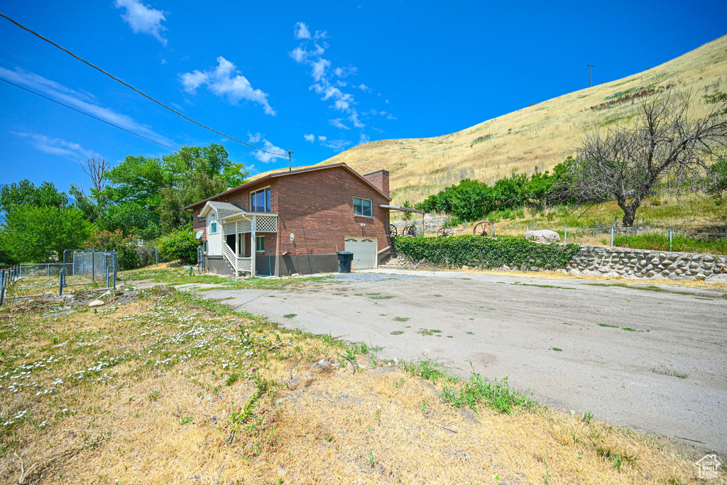 Exterior space featuring a garage and a mountain view