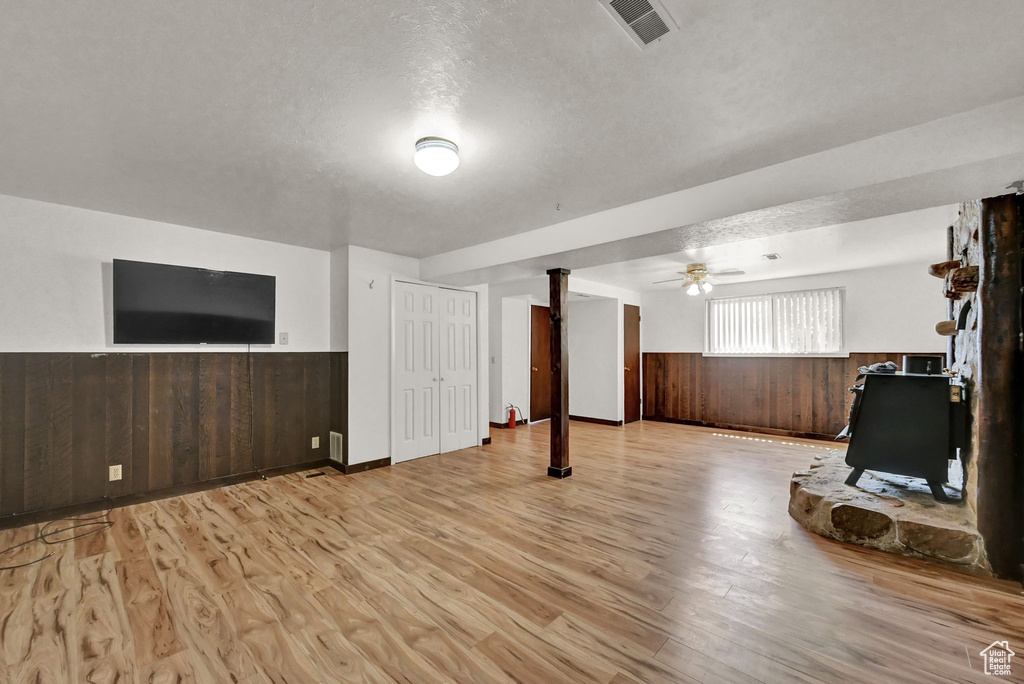 Interior space featuring light wood-type flooring, ceiling fan, and a textured ceiling