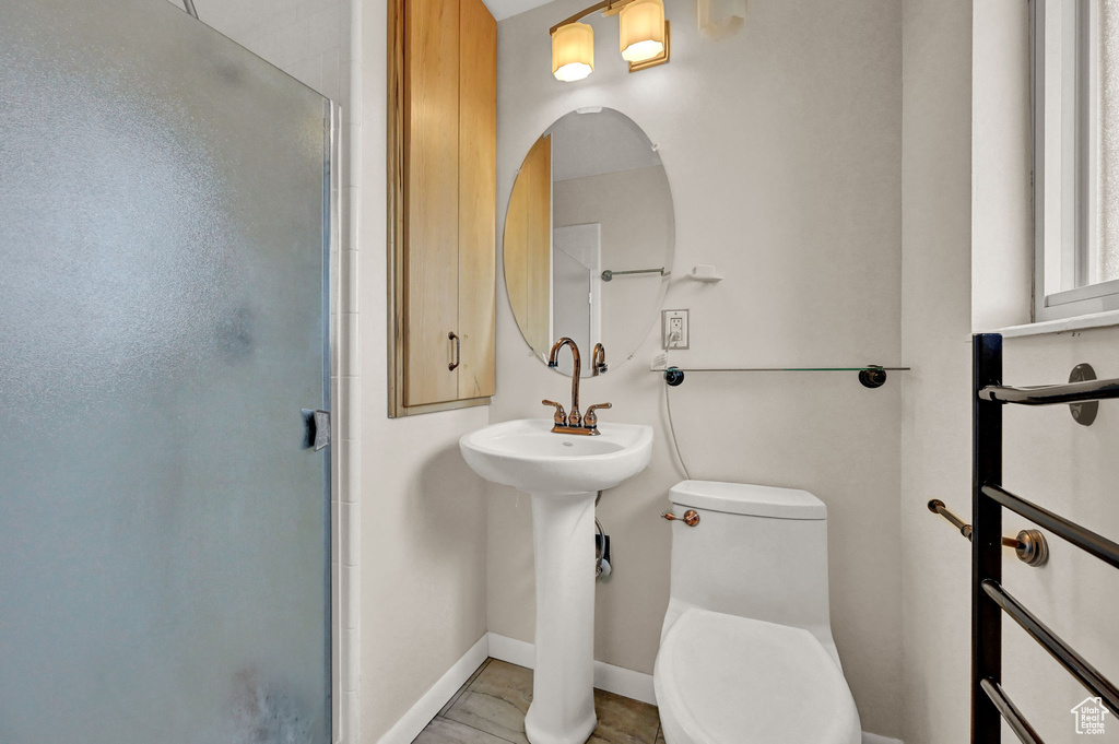 Bathroom featuring tile patterned floors, an enclosed shower, and toilet