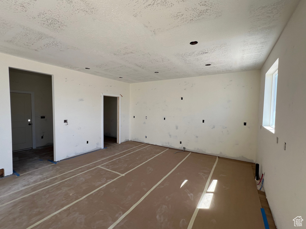 Unfurnished room featuring a textured ceiling