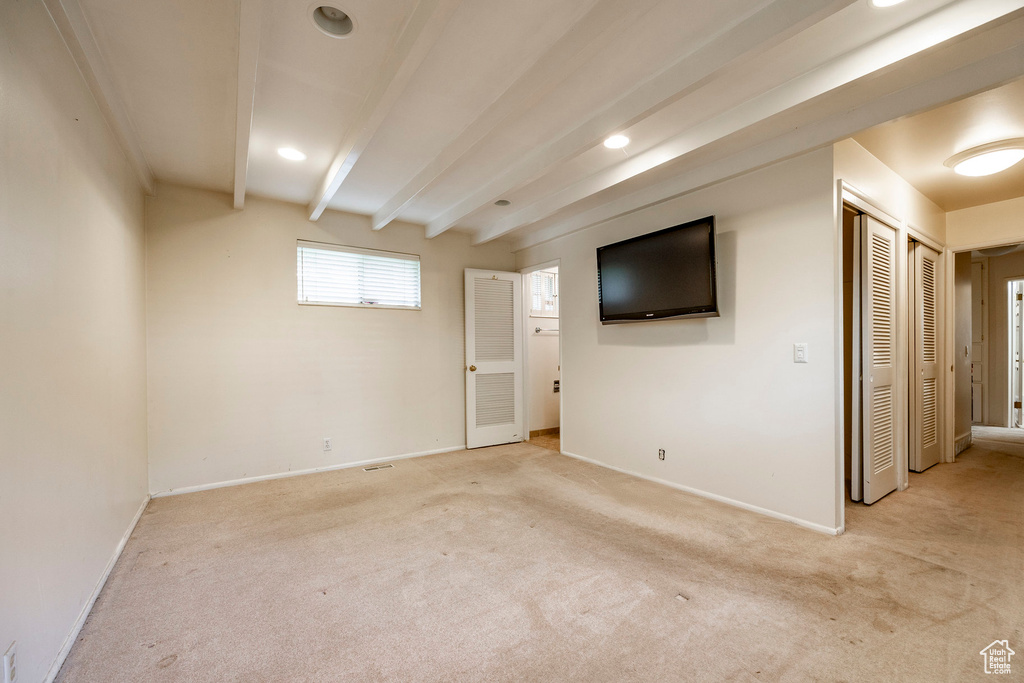 Basement featuring light carpet