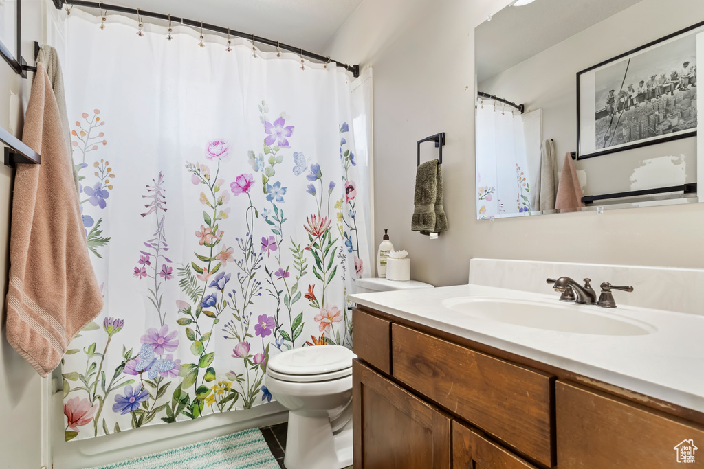 Bathroom featuring vanity, toilet, and tile patterned floors