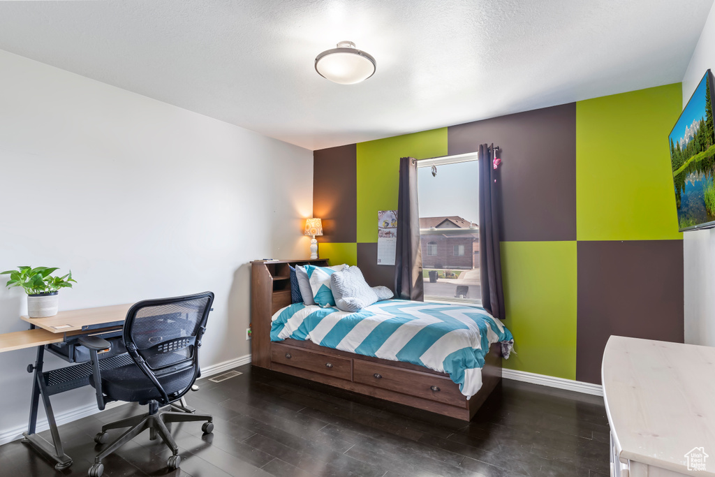 Bedroom with dark wood-type flooring