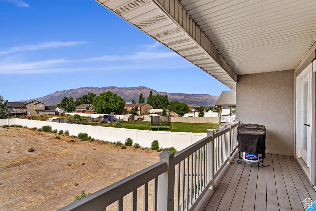 Wooden terrace with a mountain view and a grill