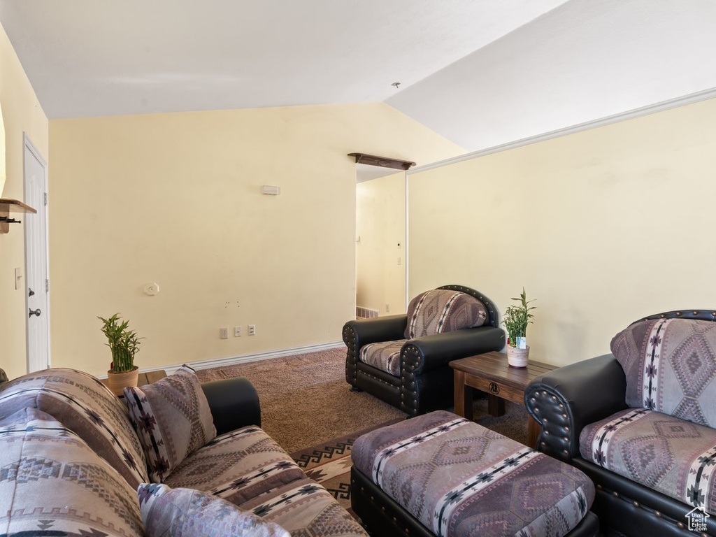 Living room featuring lofted ceiling and carpet floors