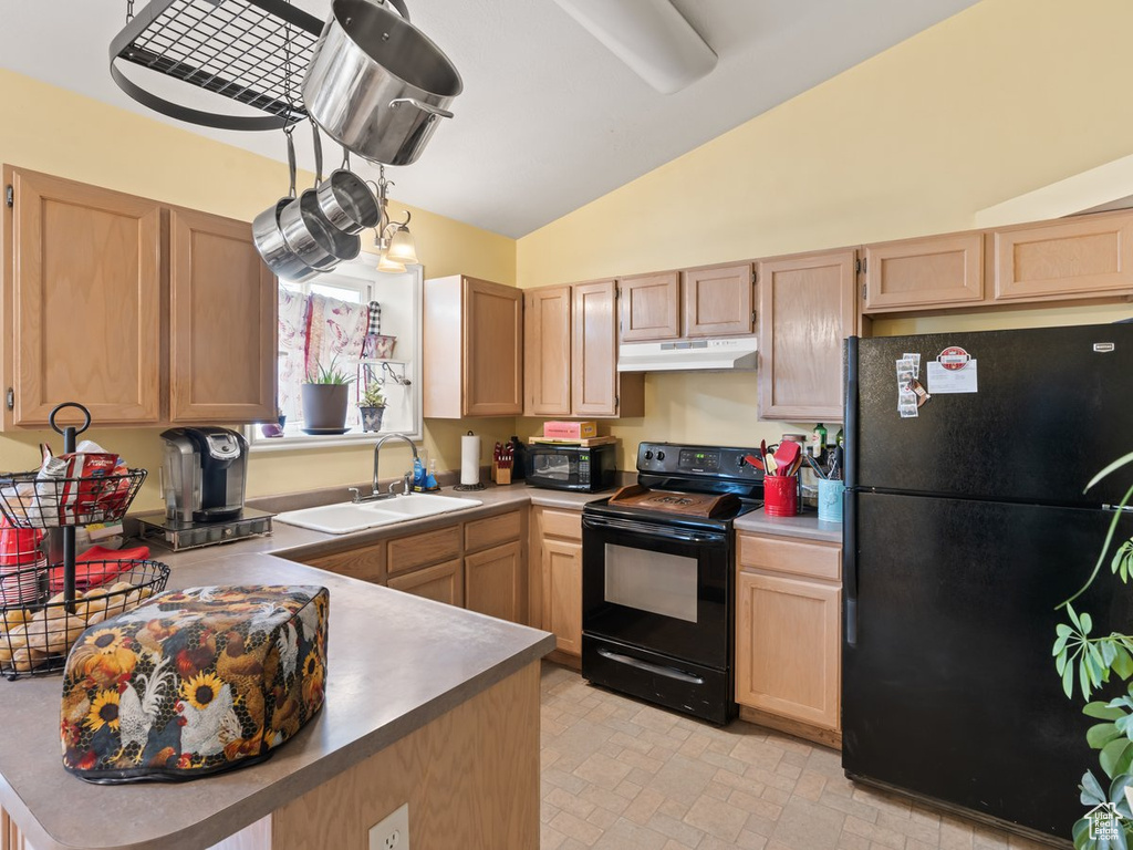 Kitchen with light tile patterned flooring, black appliances, light brown cabinetry, vaulted ceiling, and sink