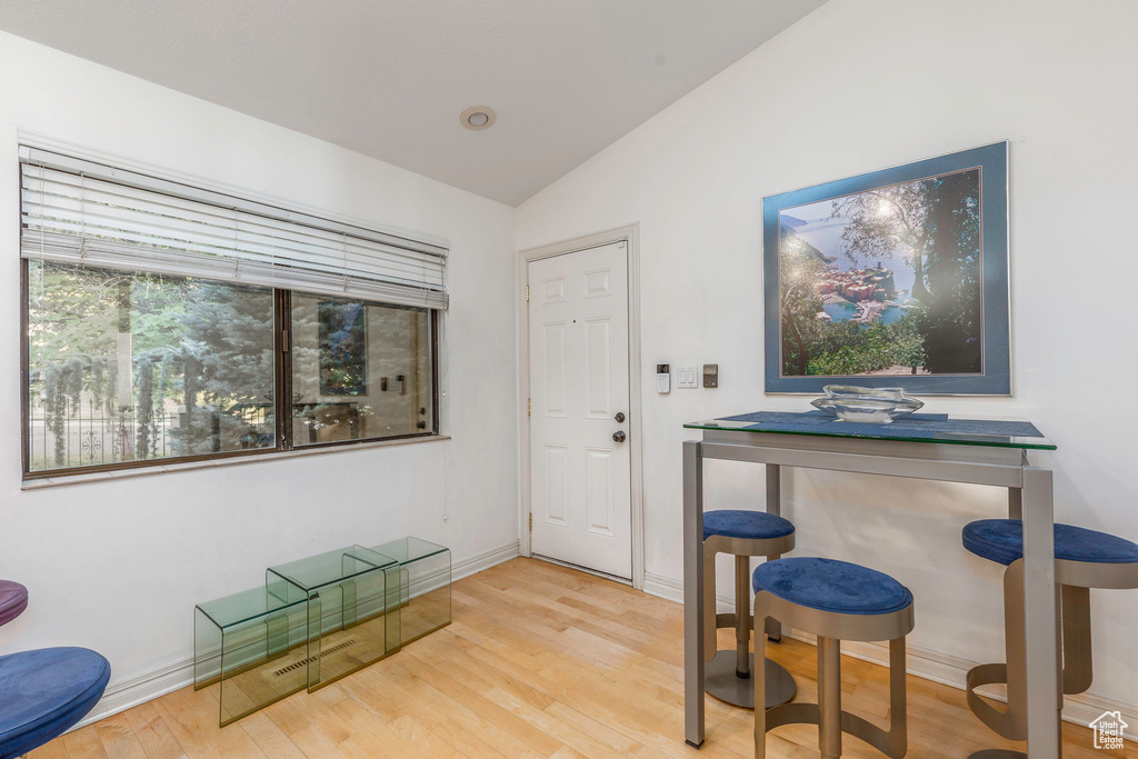 Interior space with a wealth of natural light, light hardwood / wood-style flooring, and vaulted ceiling