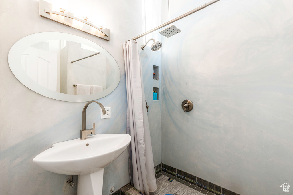 Bathroom with sink and walk in shower