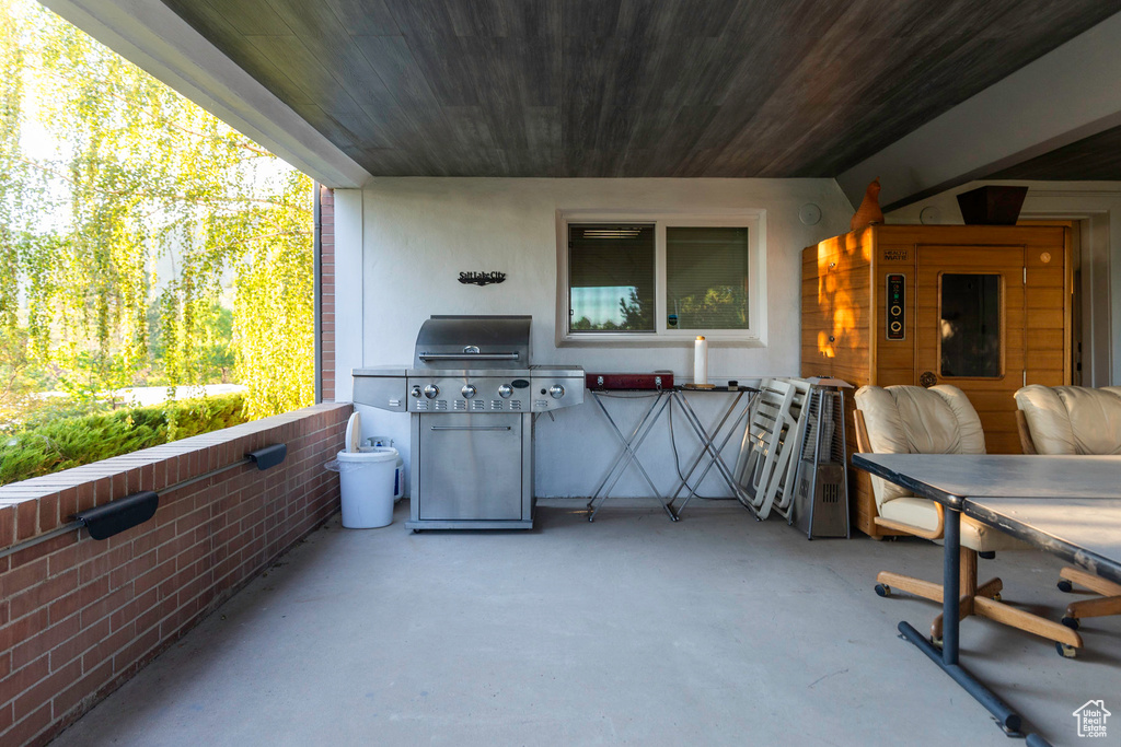 View of patio with a grill