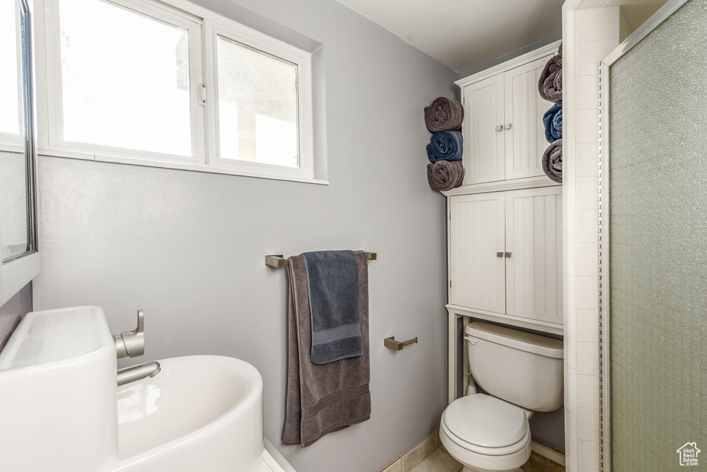 Bathroom featuring an enclosed shower and toilet