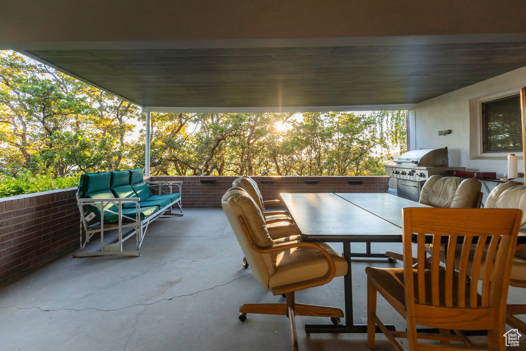 View of patio with an outdoor living space, an outdoor kitchen, and a grill