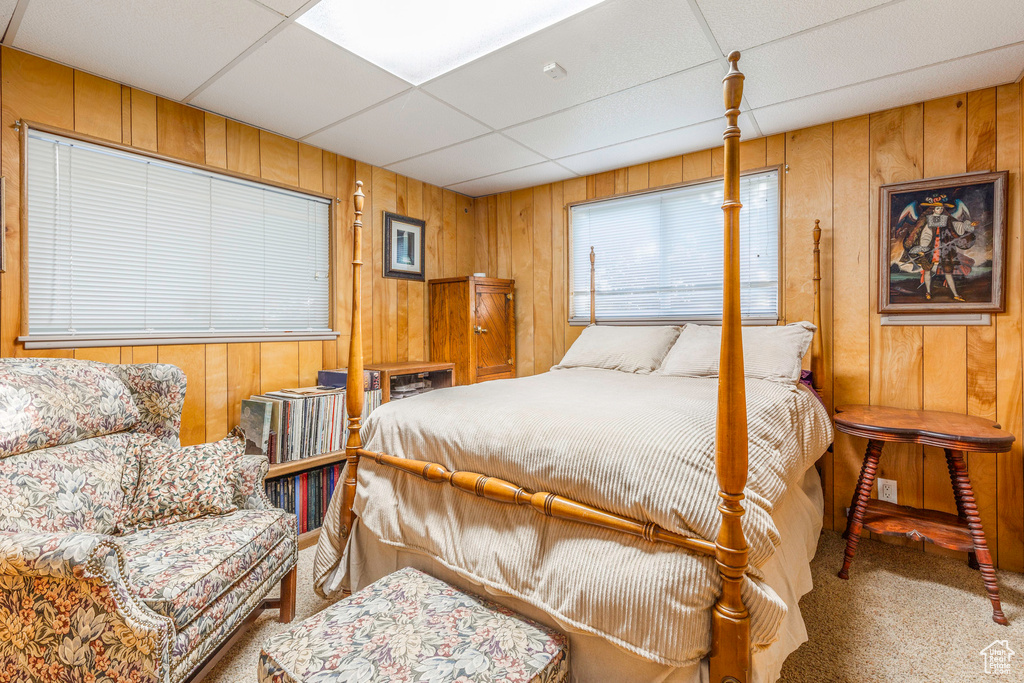 Bedroom with carpet floors and a drop ceiling