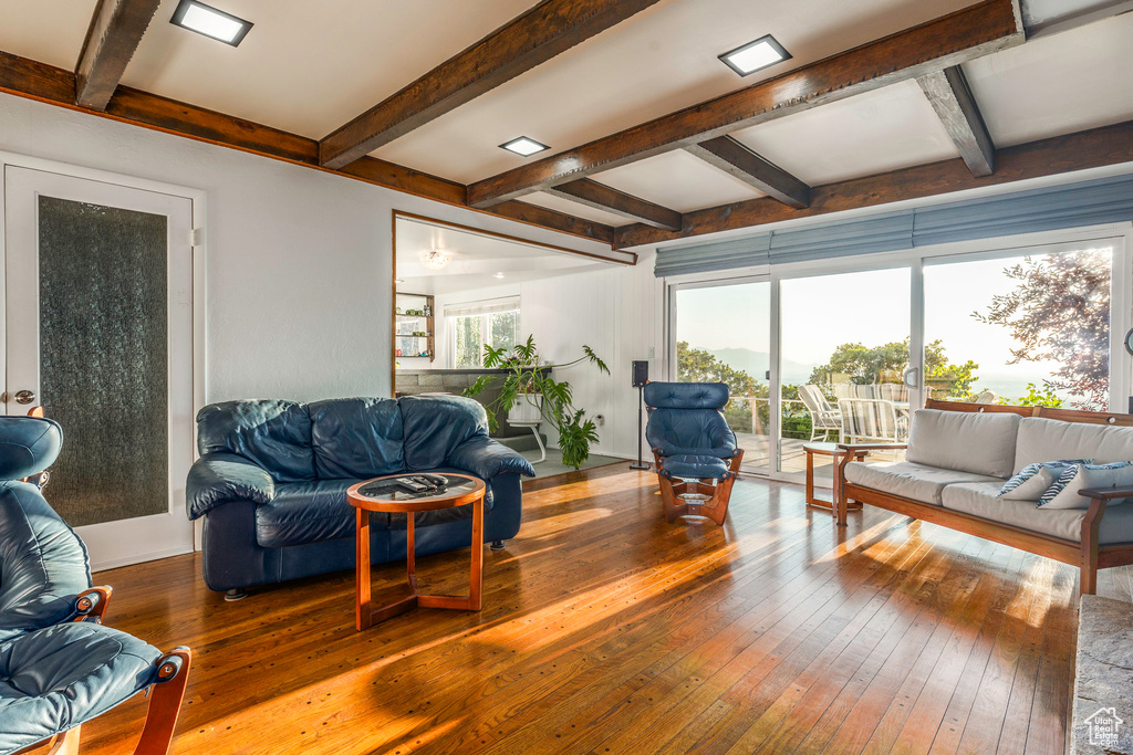 Living room with beam ceiling and wood-type flooring