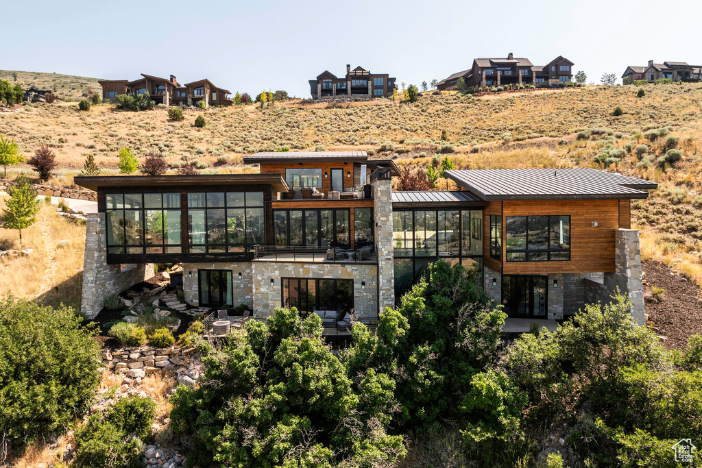 Back of property with a balcony