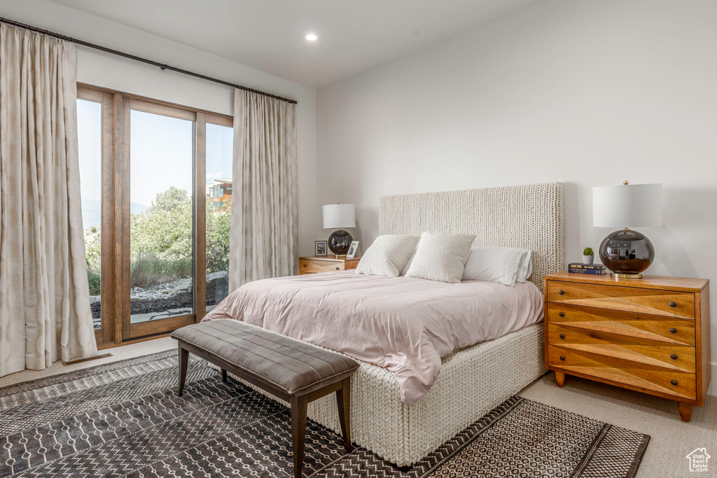 Bedroom featuring access to outside and carpet floors