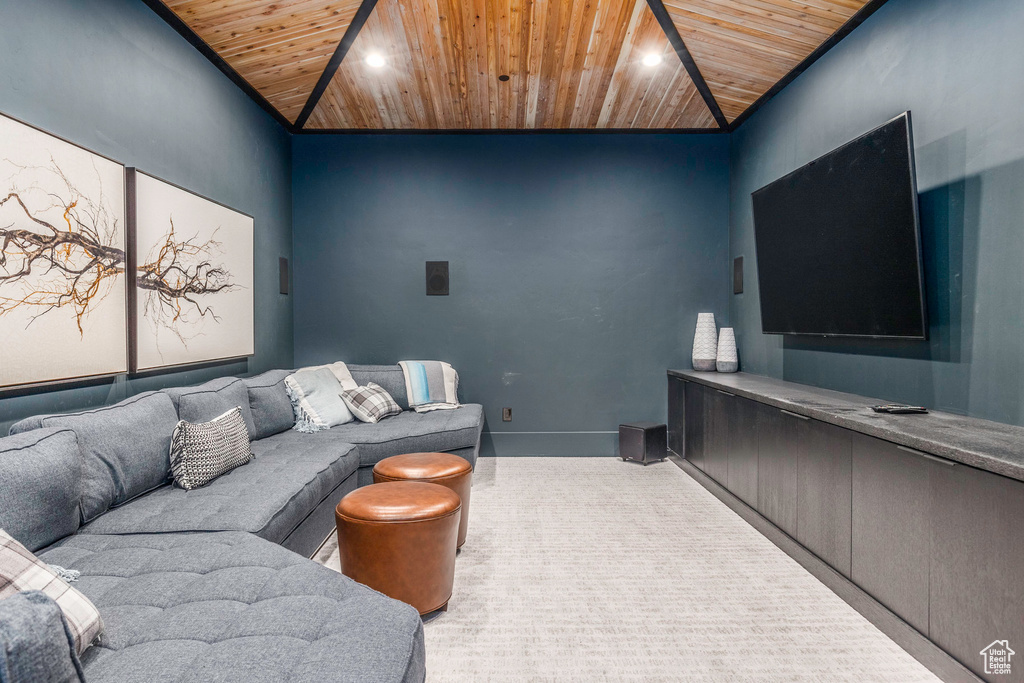 Carpeted living room featuring lofted ceiling and wood ceiling