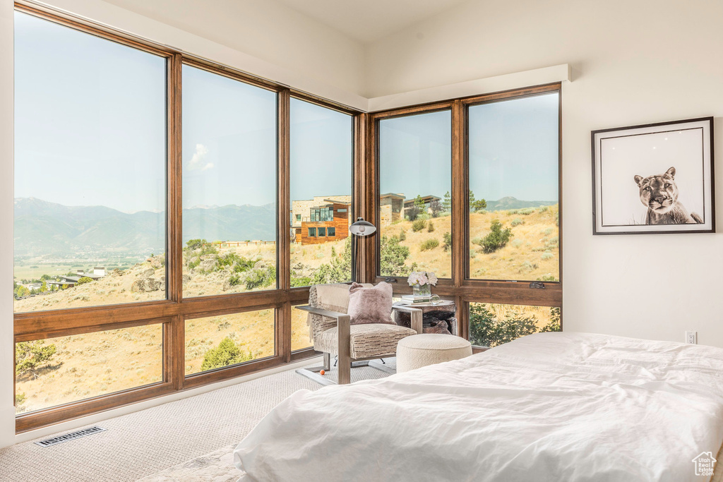 Bedroom with a mountain view and carpet flooring