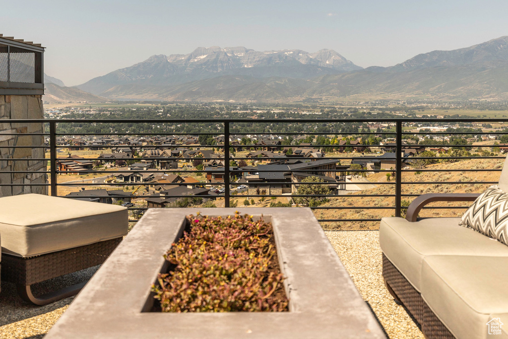 Exterior space featuring a mountain view, a balcony, and a fire pit