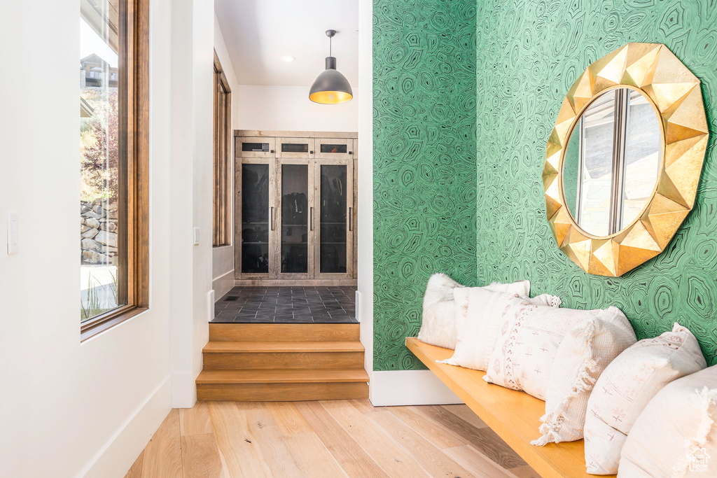 Hallway with hardwood / wood-style flooring