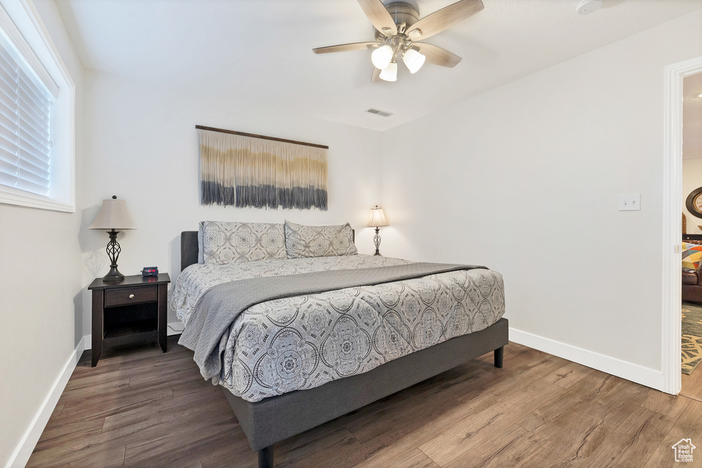 Bedroom featuring wood-type flooring and ceiling fan