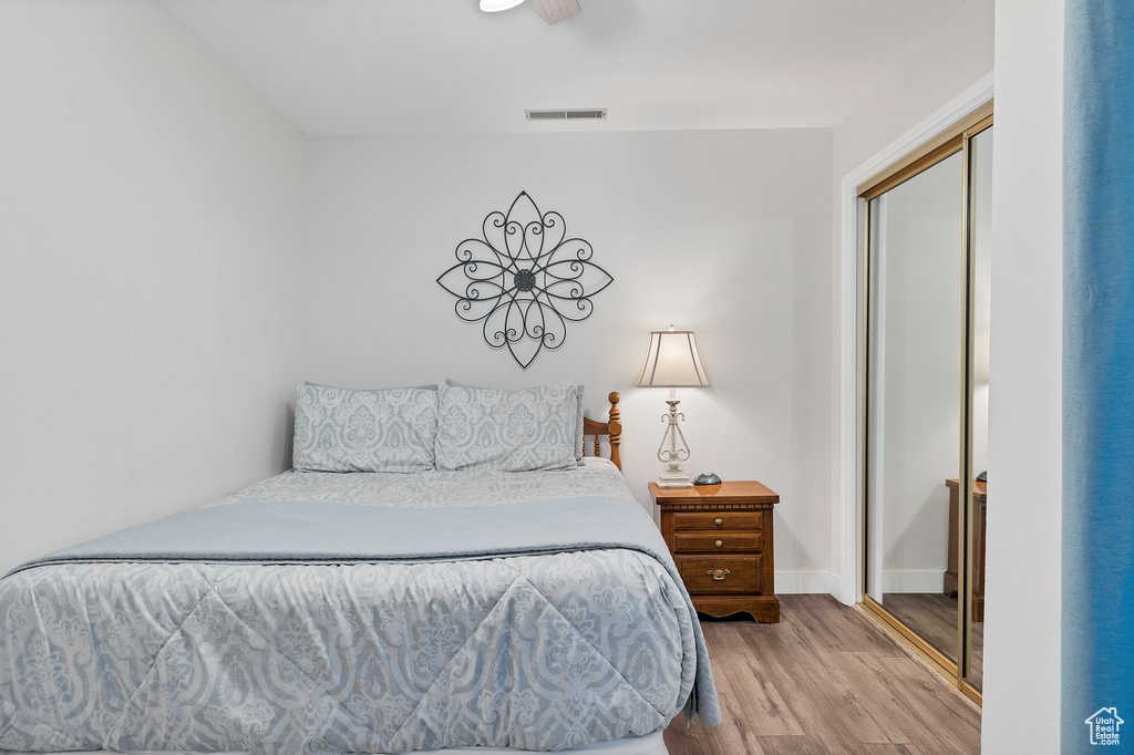 Bedroom featuring light hardwood / wood-style floors and a closet