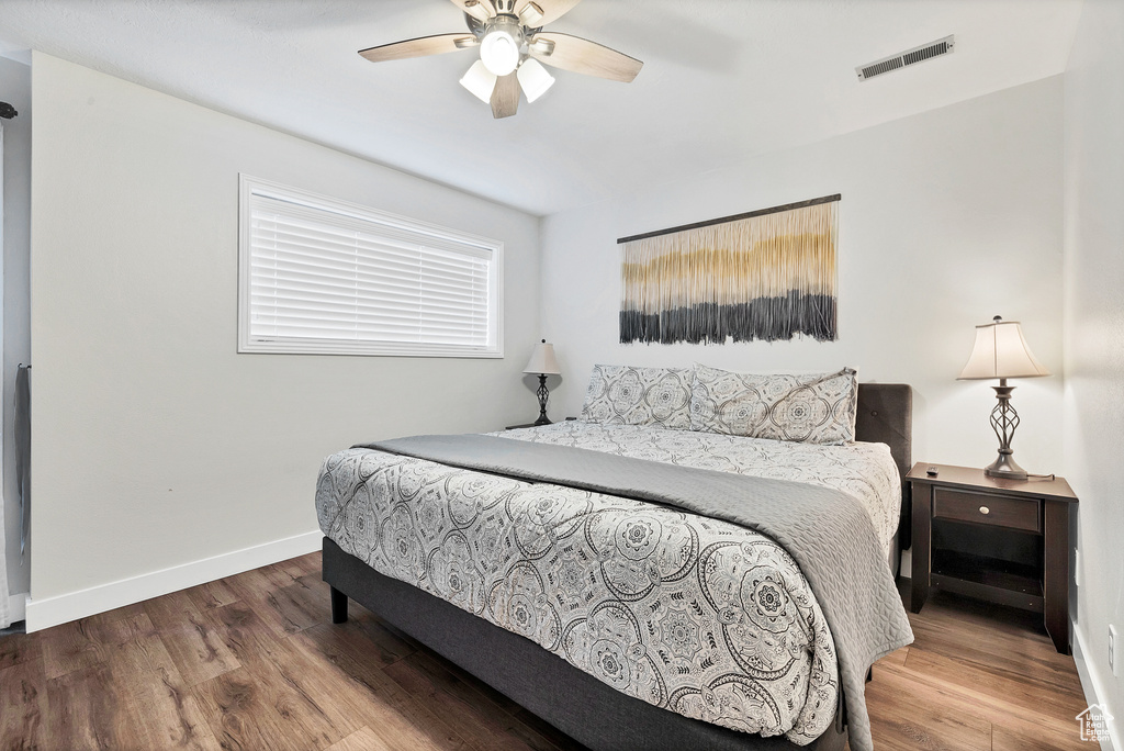 Bedroom with hardwood / wood-style flooring and ceiling fan