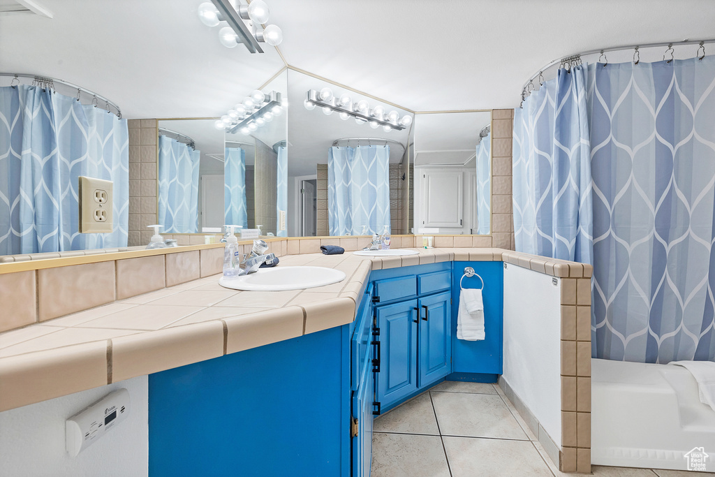 Bathroom with tile patterned flooring and dual vanity