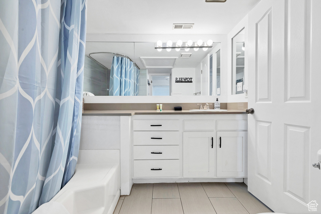 Bathroom featuring vanity and tile patterned floors