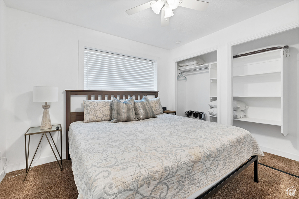 Carpeted bedroom featuring ceiling fan