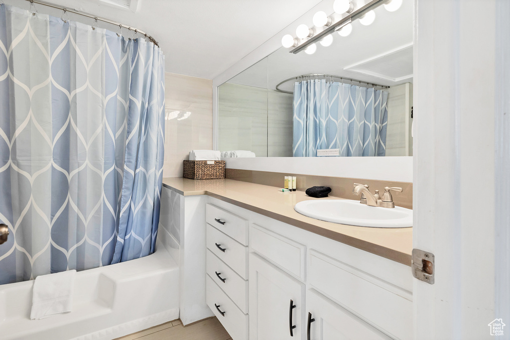 Bathroom with tile patterned floors, vanity, and shower / bath combo