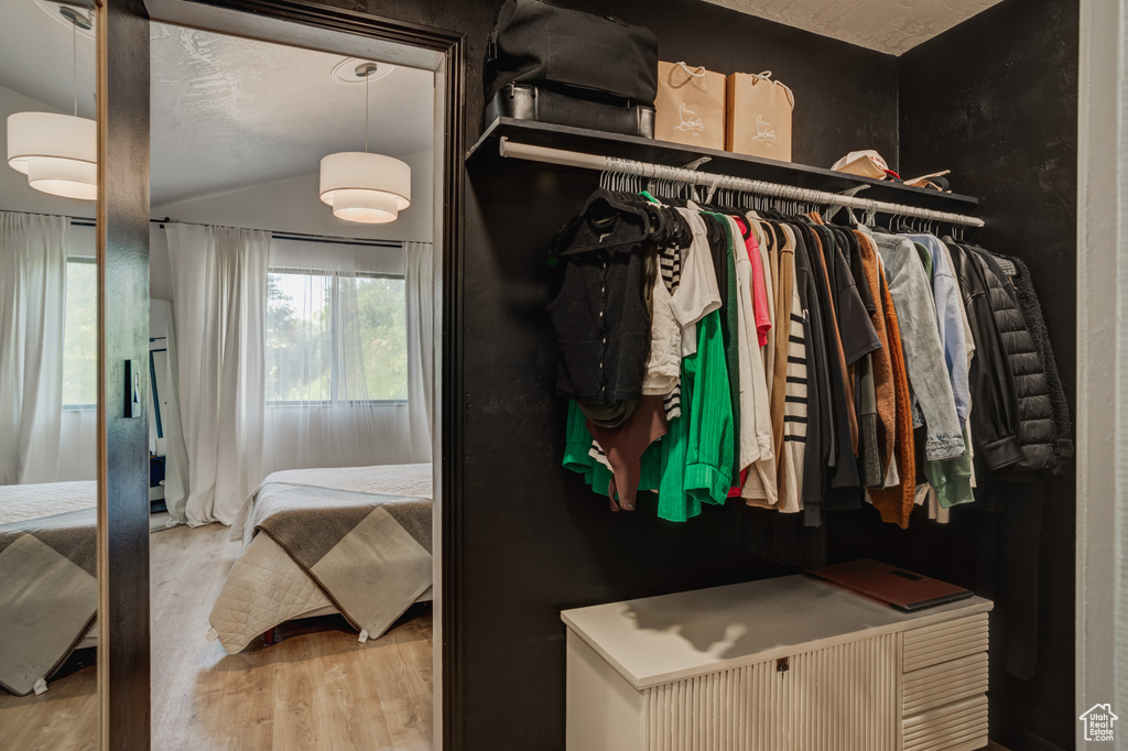 Spacious closet featuring light hardwood / wood-style flooring